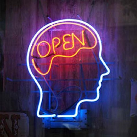 A neon light installation of an outline of a person's head and brain, with the word OPEN in the centre