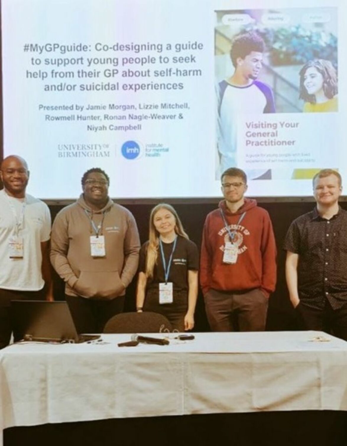 A group of young people stood in front of a presentation screen at the Young People's mental health conference in Copenhagen