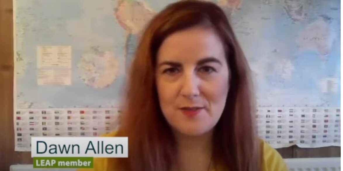 A still from a video of the PARTNERS2 project video. A woman sat at her computer talking directly to the screen, with a banner reading 'Dawn Allen, LEAP member'